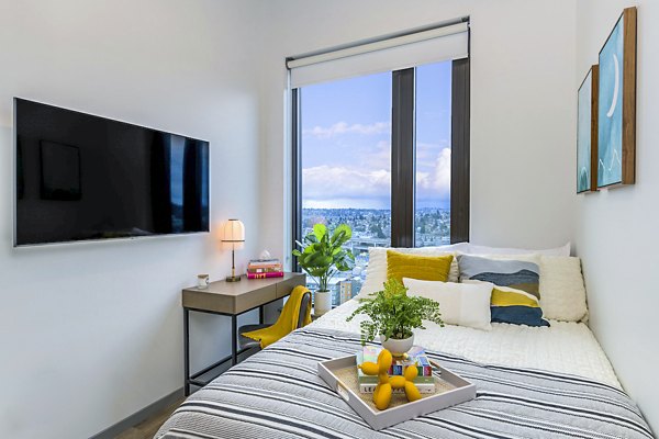 Cozy bedroom with modern decor in The Accolade Apartments, featuring stylish furnishings and ample natural light