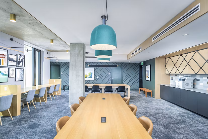 Clubhouse study area with modern seating and large windows at The Accolade Apartments, perfect for productive sessions and relaxation
