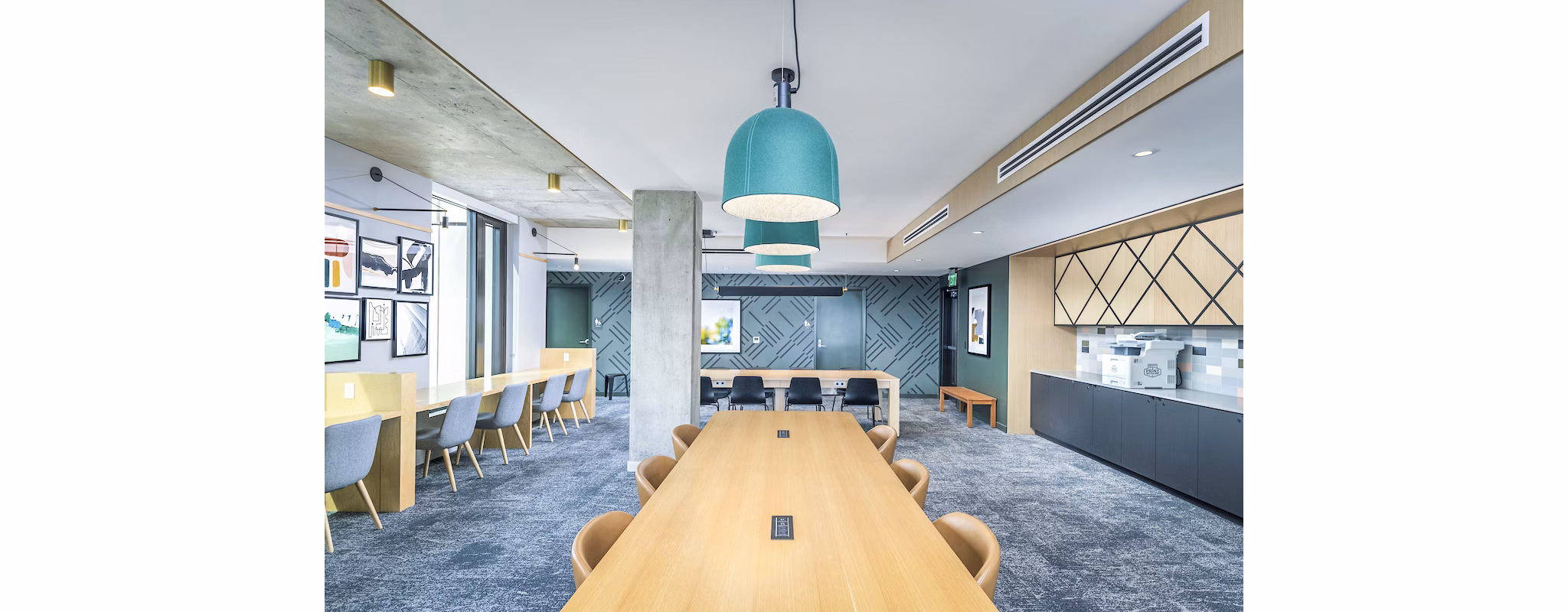 Clubhouse study area with modern seating and large windows at The Accolade Apartments, perfect for productive sessions and relaxation