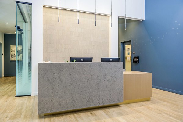 The Accolade: Luxurious clubhouse lobby with modern front desk at The Accolade Apartments in vibrant urban setting