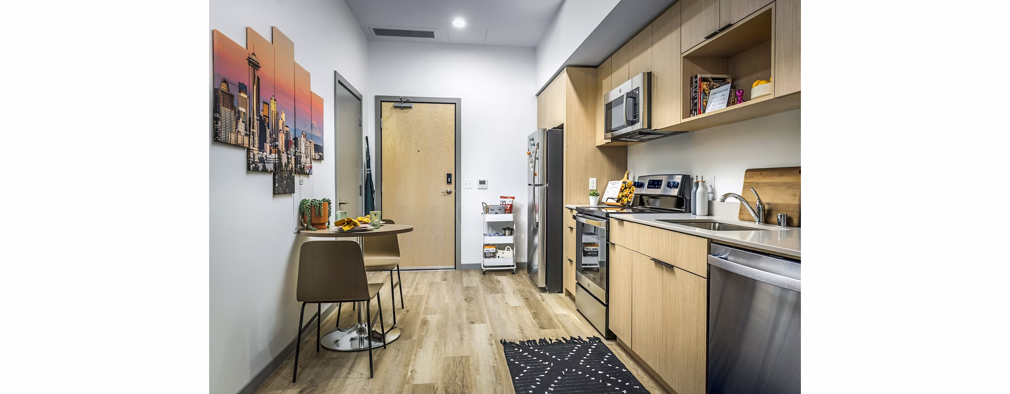 Open kitchen and entryway with modern appliances in The Accolade Apartments luxury complex