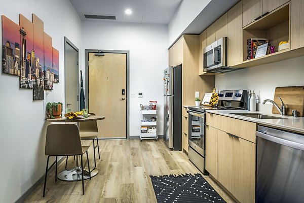 Open kitchen and entryway with modern appliances in The Accolade Apartments luxury complex