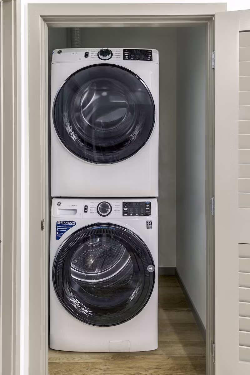Laundry room with modern washers and dryers at The Accolade Apartments