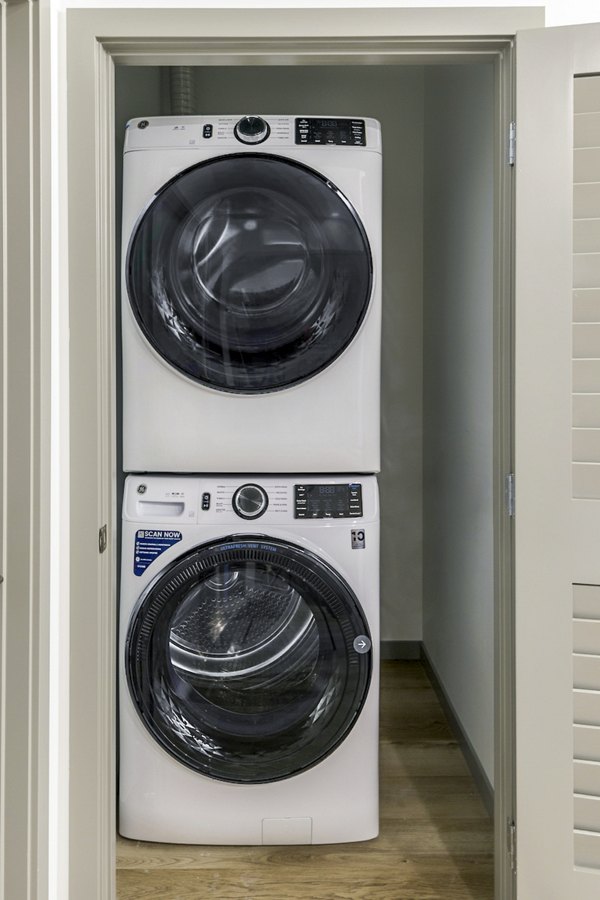 Laundry room with modern washers and dryers at The Accolade Apartments