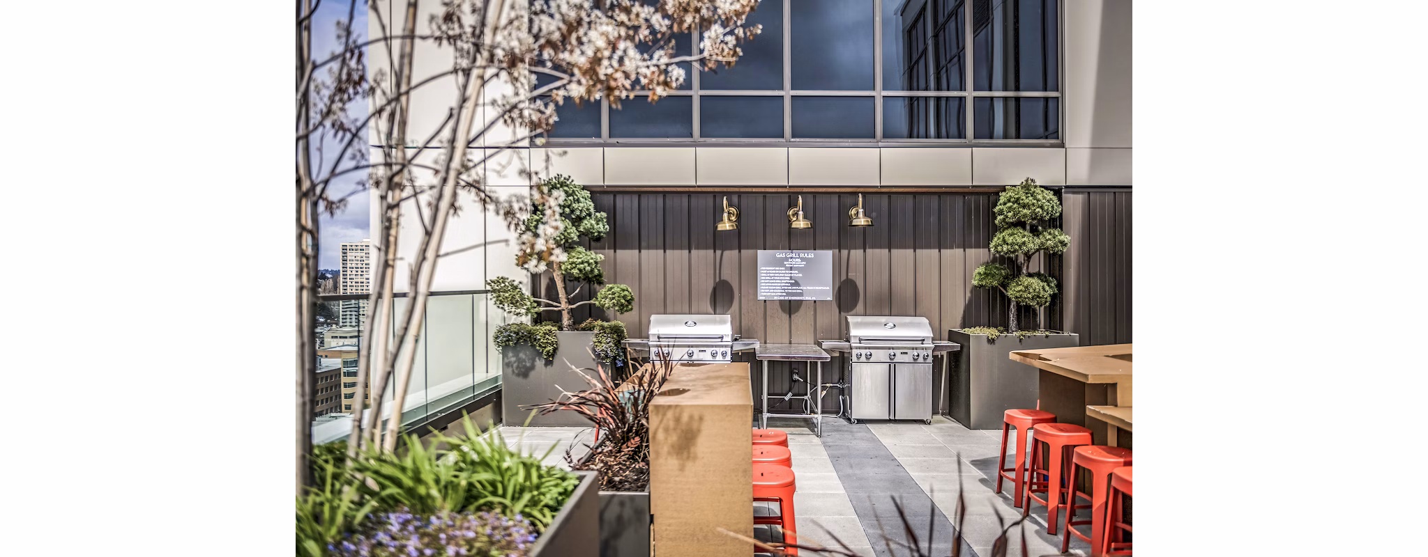 Grill area with modern patio furniture at The Accolade Apartments