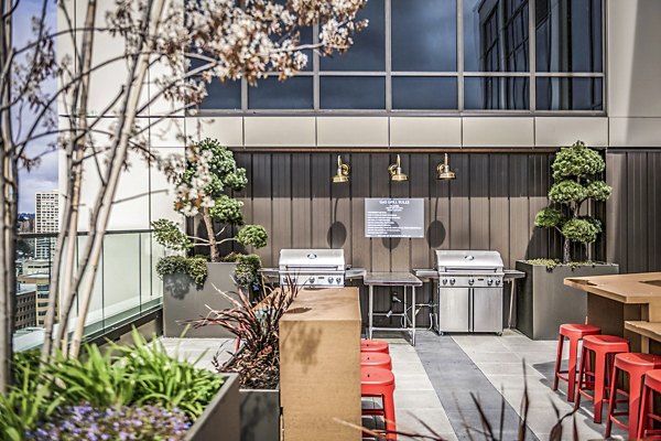 Grill area with modern patio furniture at The Accolade Apartments