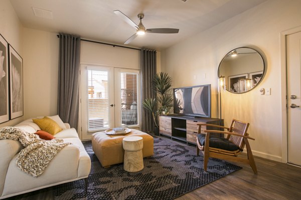 Cozy living room with neutral palette and modern furnishings at South Meadows Apartments
