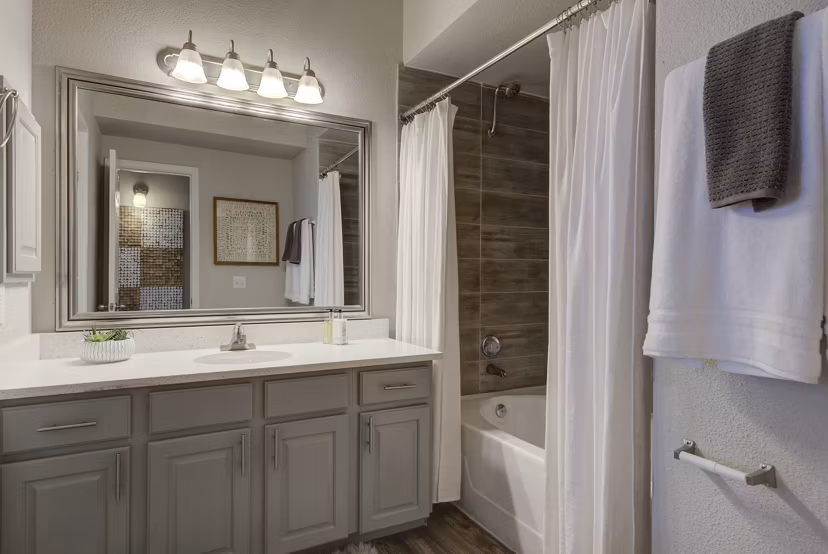 Elegant bathroom with marble countertops and modern fixtures at Preston Peak Apartments