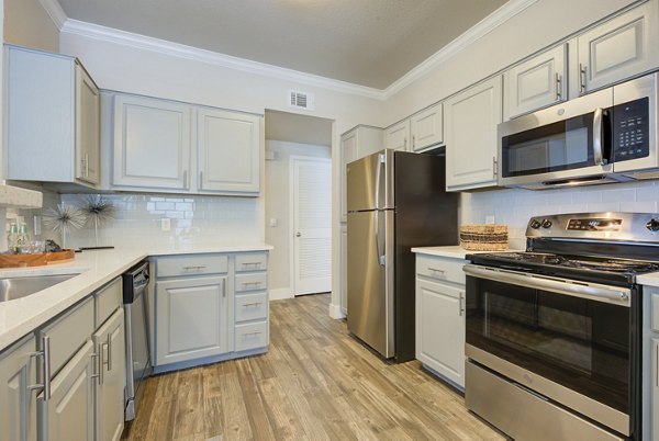 Modern kitchen with stainless steel appliances at Preston Peak Apartments