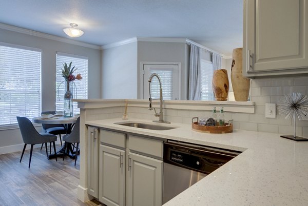 Modern kitchen with stainless steel appliances in Preston Peak Apartments
