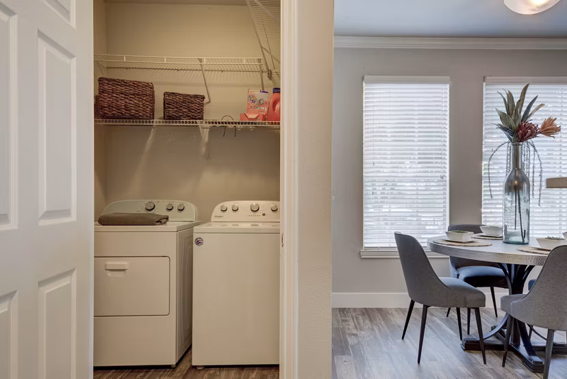 Laundry room featuring modern appliances at Preston Peak Apartments, a luxury community by Greystar
