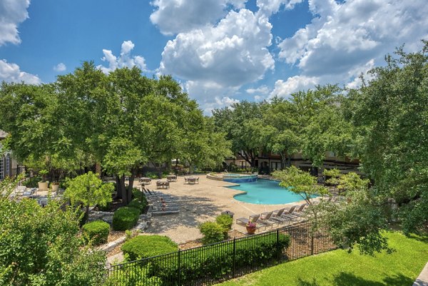 Resort-style pool with sun loungers at Preston Peak Apartments, ideal for relaxation and leisure