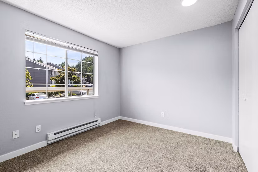 Luxurious bedroom featuring modern decor and ample natural light at Avana West Hill Apartments