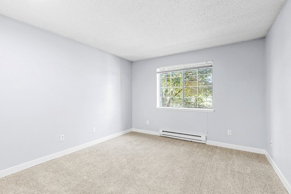 Cozy bedroom featuring modern furnishings and soft lighting at Avana West Hill Apartments