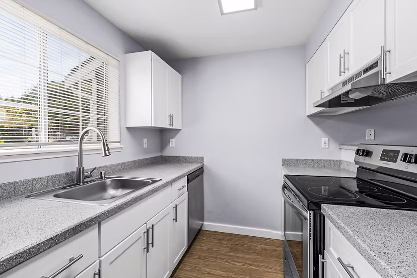Modern kitchen with stainless steel appliances in Avana West Hill Apartments