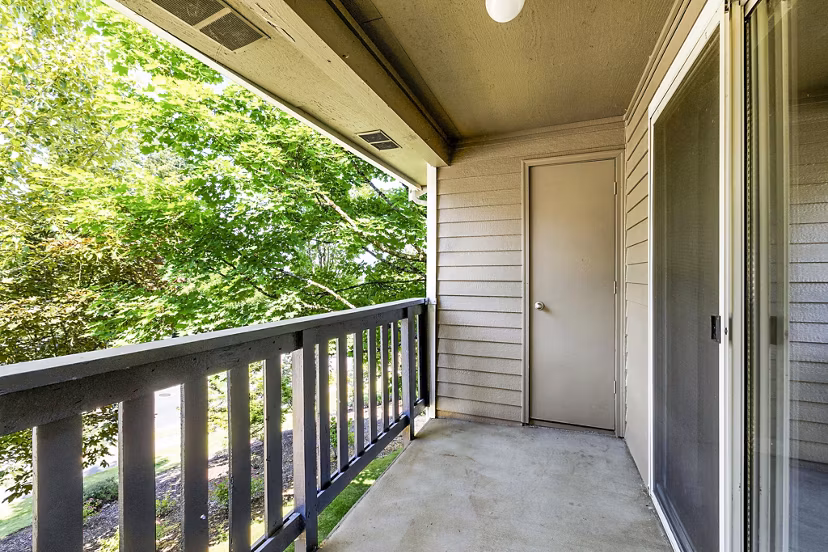 Cozy outdoor patio at Avana West Hill Apartments with seating and lush greenery, perfect for relaxation in vibrant community settings