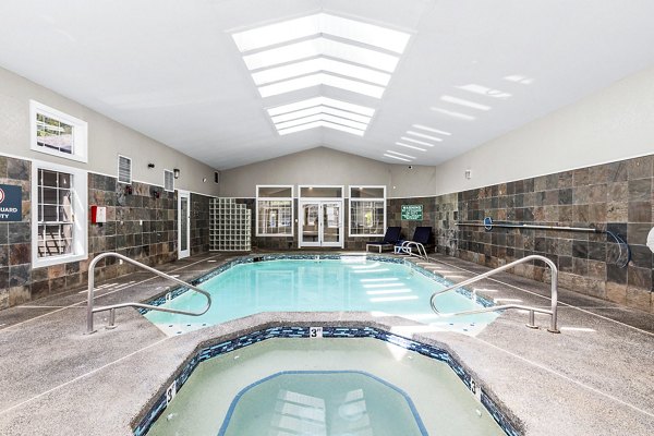 Rooftop pool with sun loungers at Avana West Hill Apartments, luxury living in a serene setting