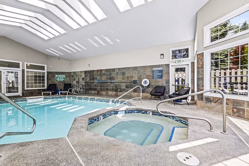 Rooftop pool with lounge seating at Avana West Hill Apartments
