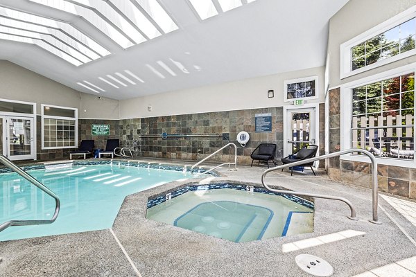 Rooftop pool with lounge seating at Avana West Hill Apartments