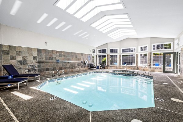 Relaxing pool area with lounge chairs at Avana West Hill Apartments, perfect for leisure and community gatherings