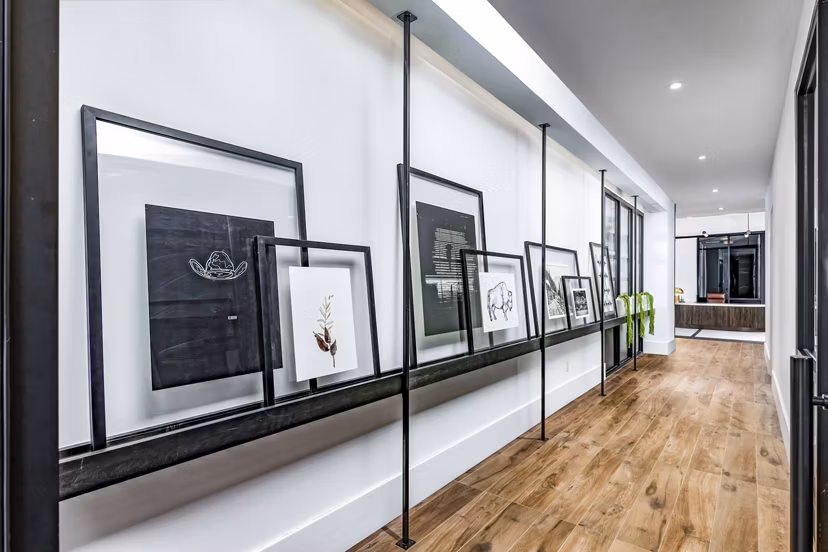 Harlowe Apartments: Sleek clubhouse hallway with contemporary design in luxury Greystar community
