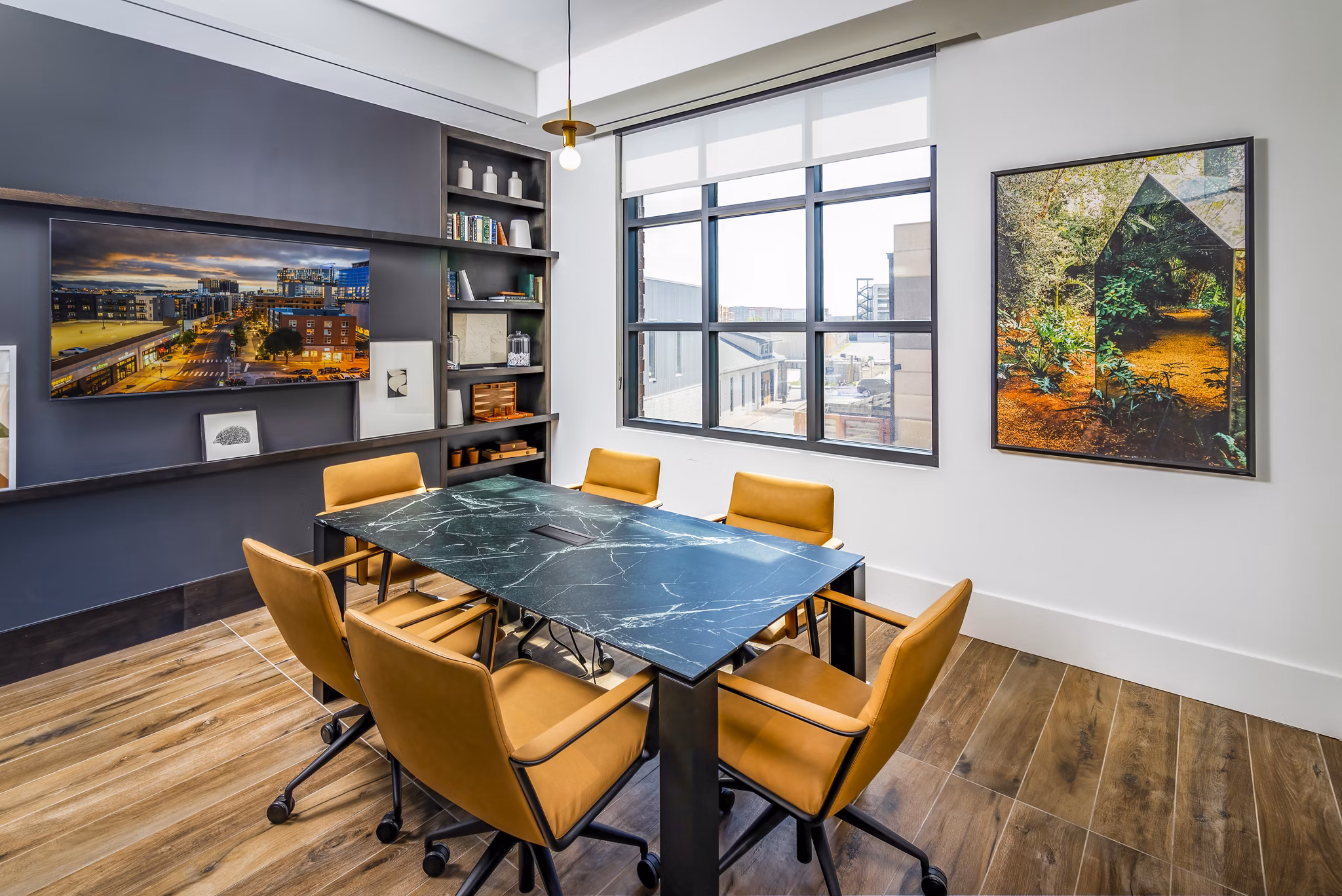 Clubhouse meeting facility with modern seating arrangements at Harlowe Apartments for a welcoming and versatile event space