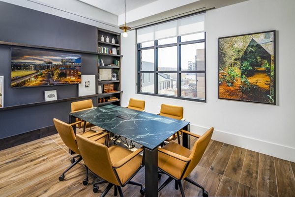 Clubhouse meeting facility with modern seating arrangements at Harlowe Apartments for a welcoming and versatile event space