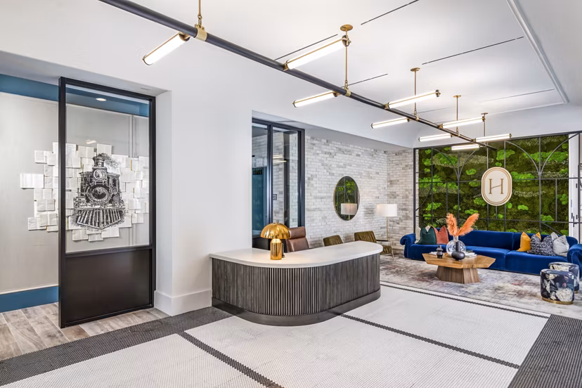 Stylish clubhouse lobby with modern decor and seating at Harlowe Apartments, a luxury community by Greystar