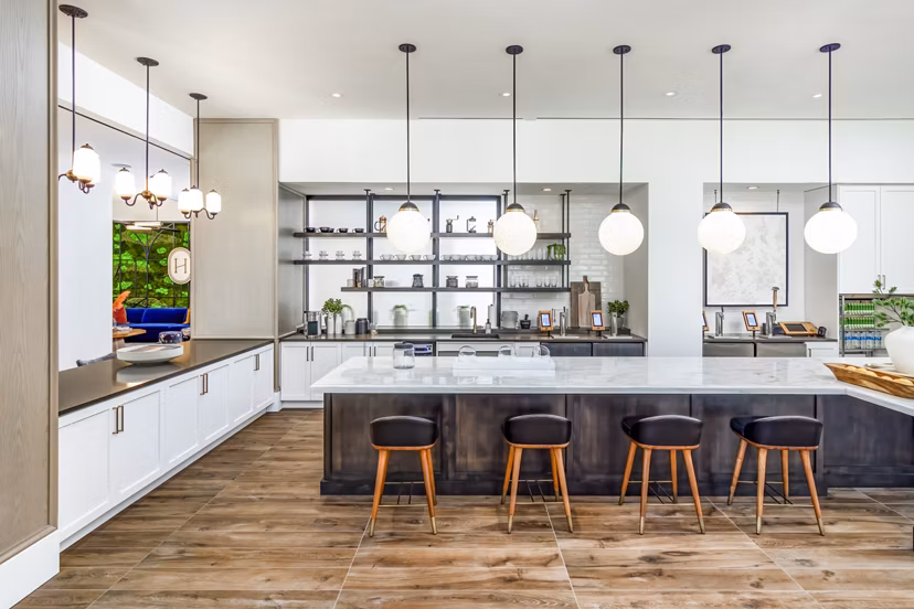 Modern clubhouse with cozy seating and entertainment area at Harlowe Apartments, offering luxury living experiences in style