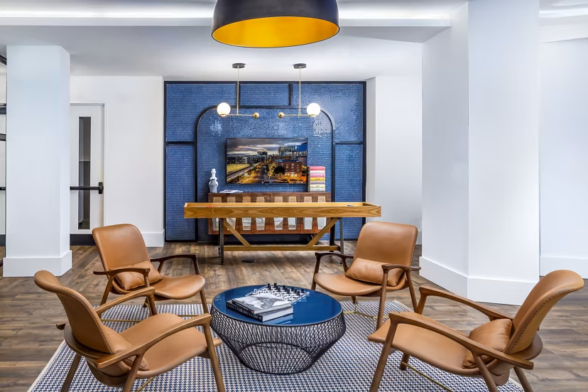 Clubhouse game room with modern decor at Harlowe Apartments, a luxury property by Greystar