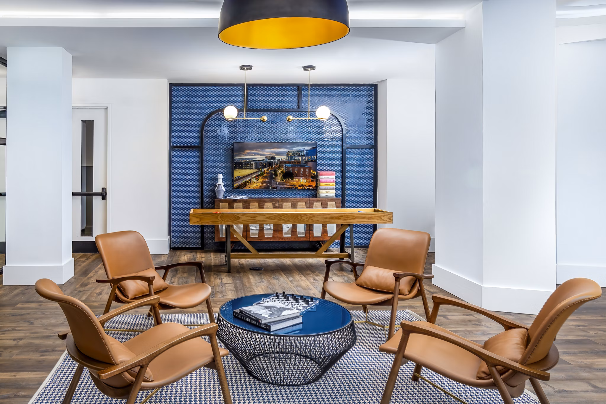 Clubhouse game room with modern decor at Harlowe Apartments, a luxury property by Greystar