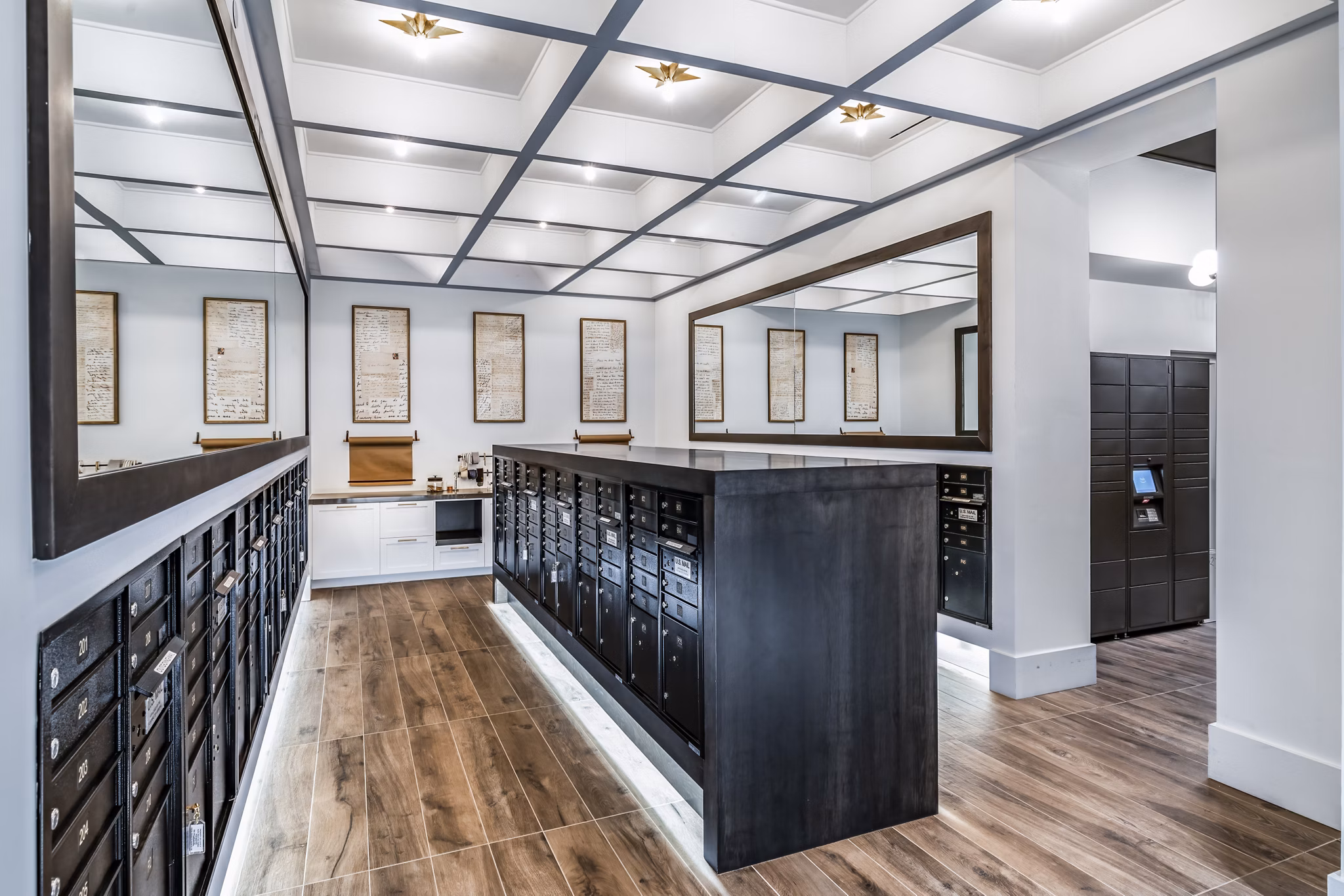 Clubhouse mail room at Harlowe Apartments featuring organized parcel lockers and modern design elements Ideal for residents' package management