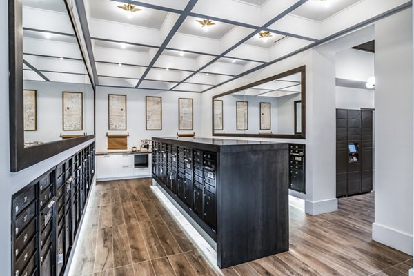 Clubhouse mail room at Harlowe Apartments featuring organized parcel lockers and modern design elements Ideal for residents' package management