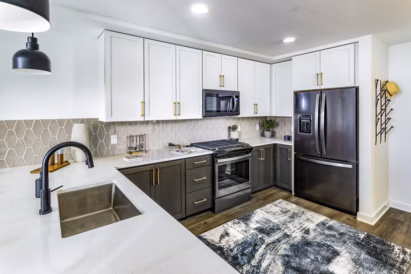 Modern kitchen with sleek cabinetry and stainless steel appliances in Harlowe Apartments