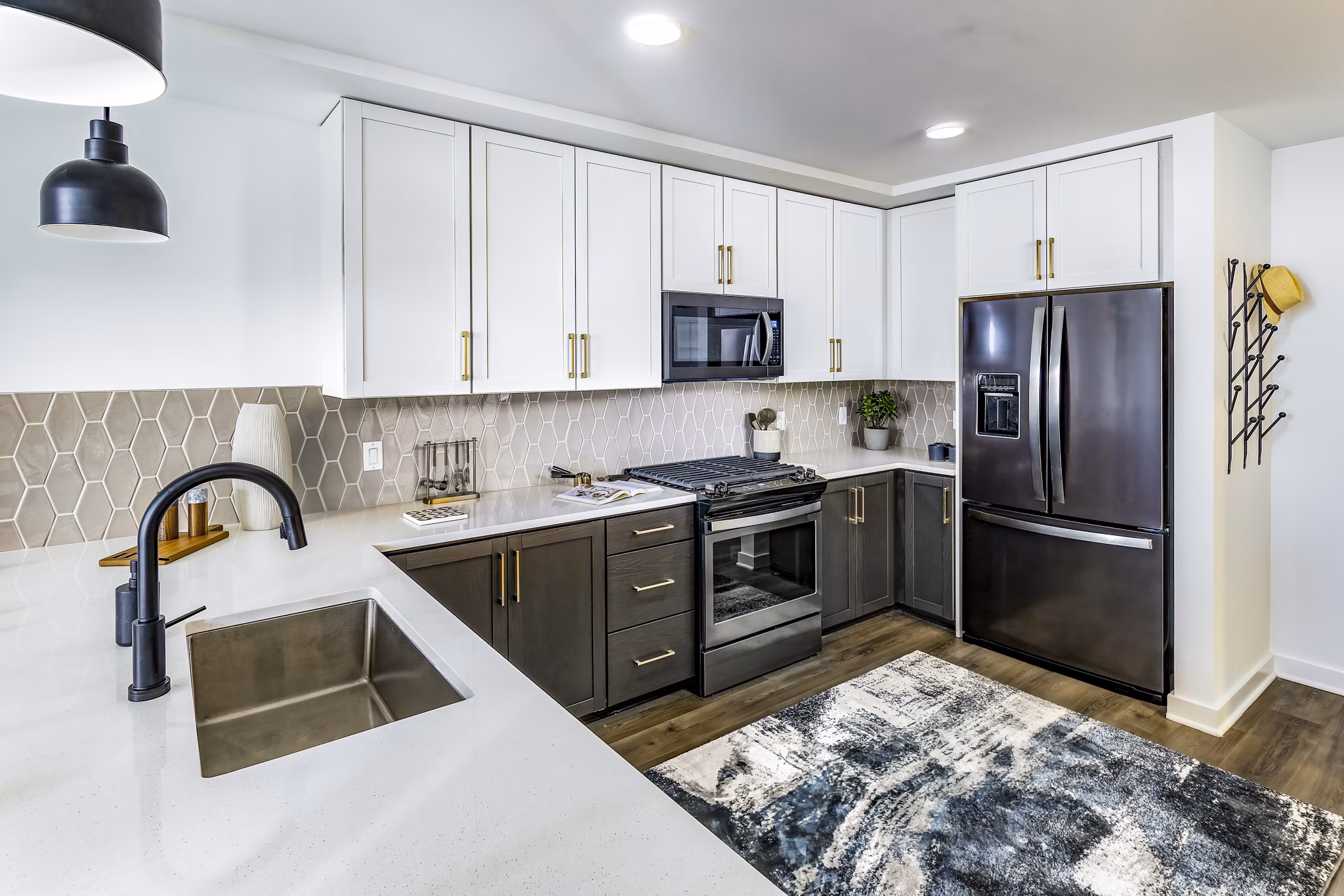 Modern kitchen with sleek cabinetry and stainless steel appliances in Harlowe Apartments