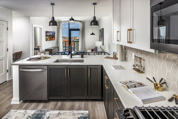 Modern kitchen with stainless steel appliances and sleek countertops at Harlowe Apartments, a Greystar-managed property