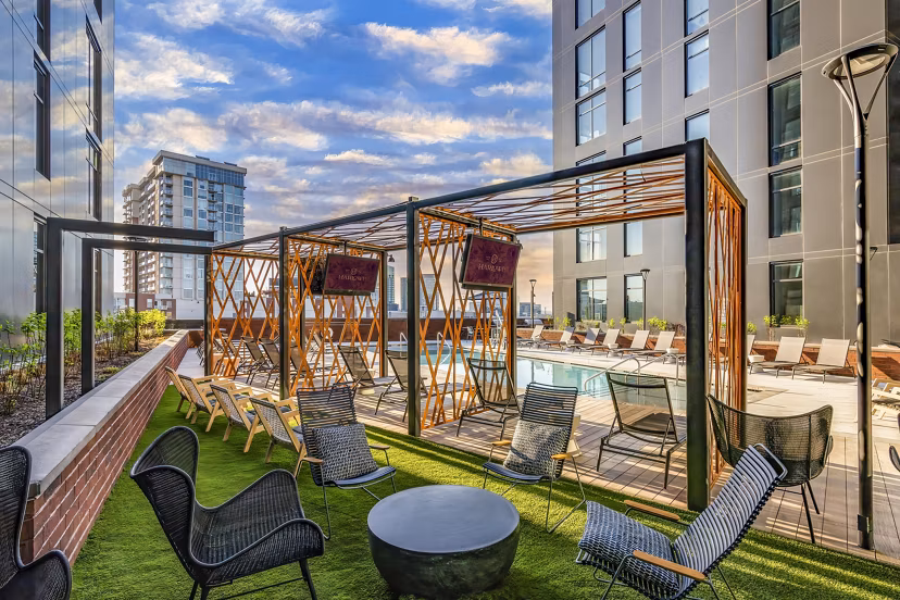 Pool patio at Harlowe Apartments - Modern relaxing pool area with lounge seating perfect for socializing and enjoying sunny days