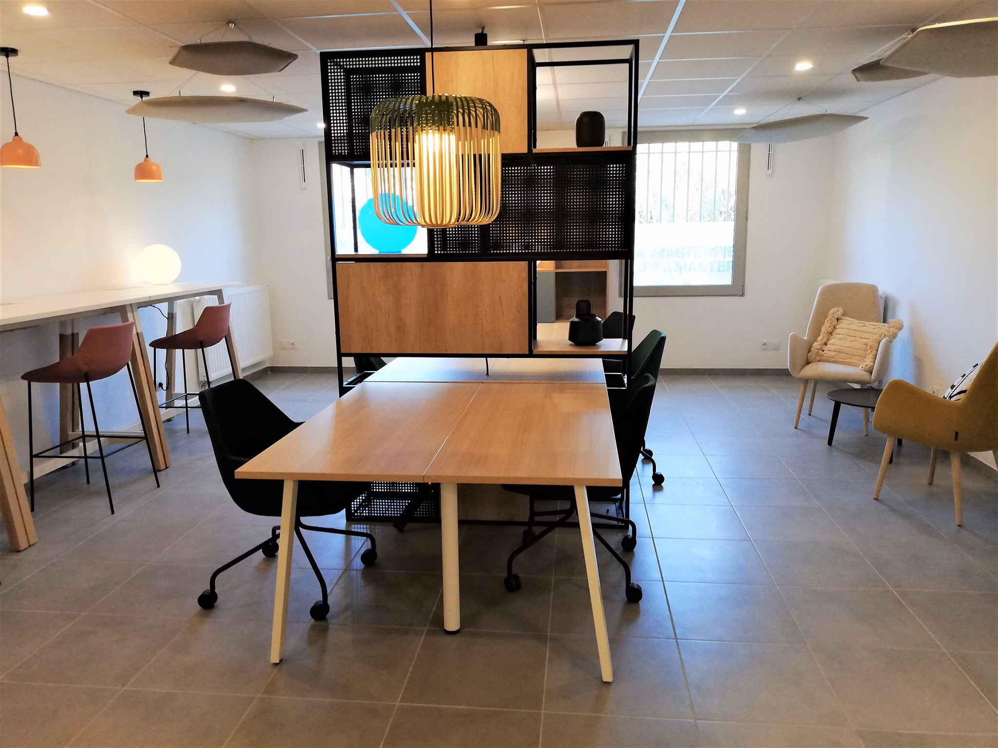 Open common area with contemporary seating, natural lighting, and modern decor in a spacious layout.
