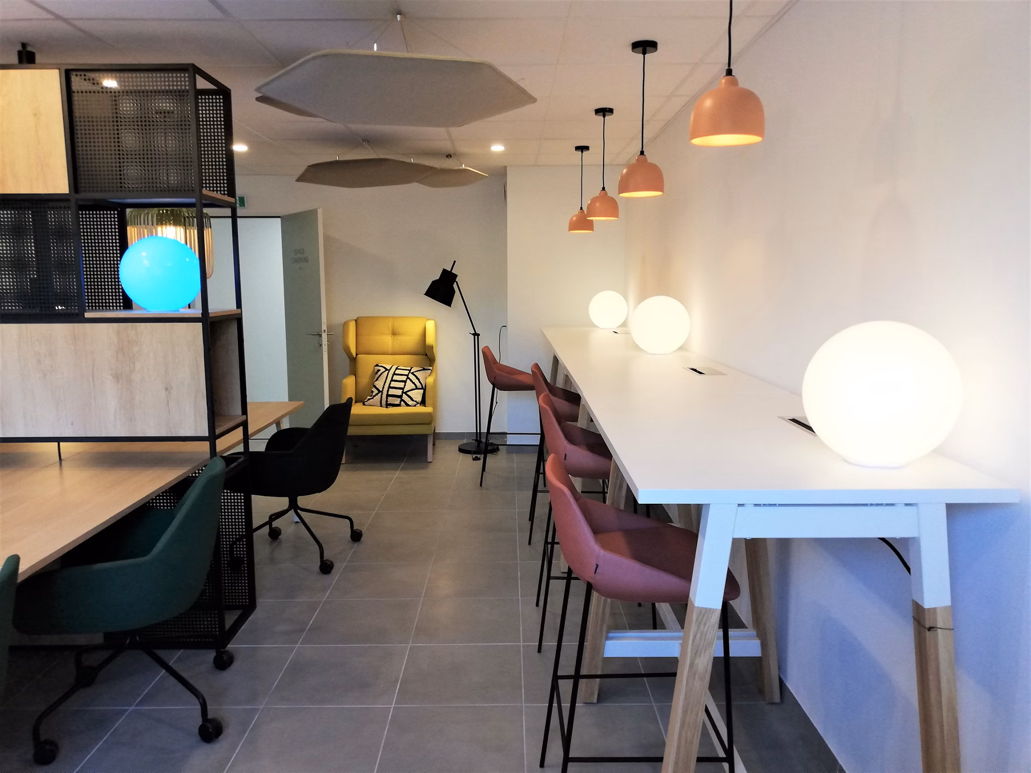 Stylish common area featuring a bar setup, pendant lighting, and modern furniture creating a lively environment.