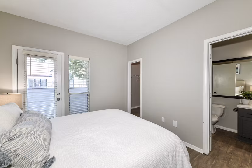 Cozy bedroom with modern decor and ample natural light at Avana Dunwoody Apartments