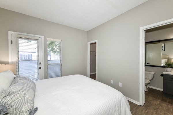 Cozy bedroom with modern decor and ample natural light at Avana Dunwoody Apartments