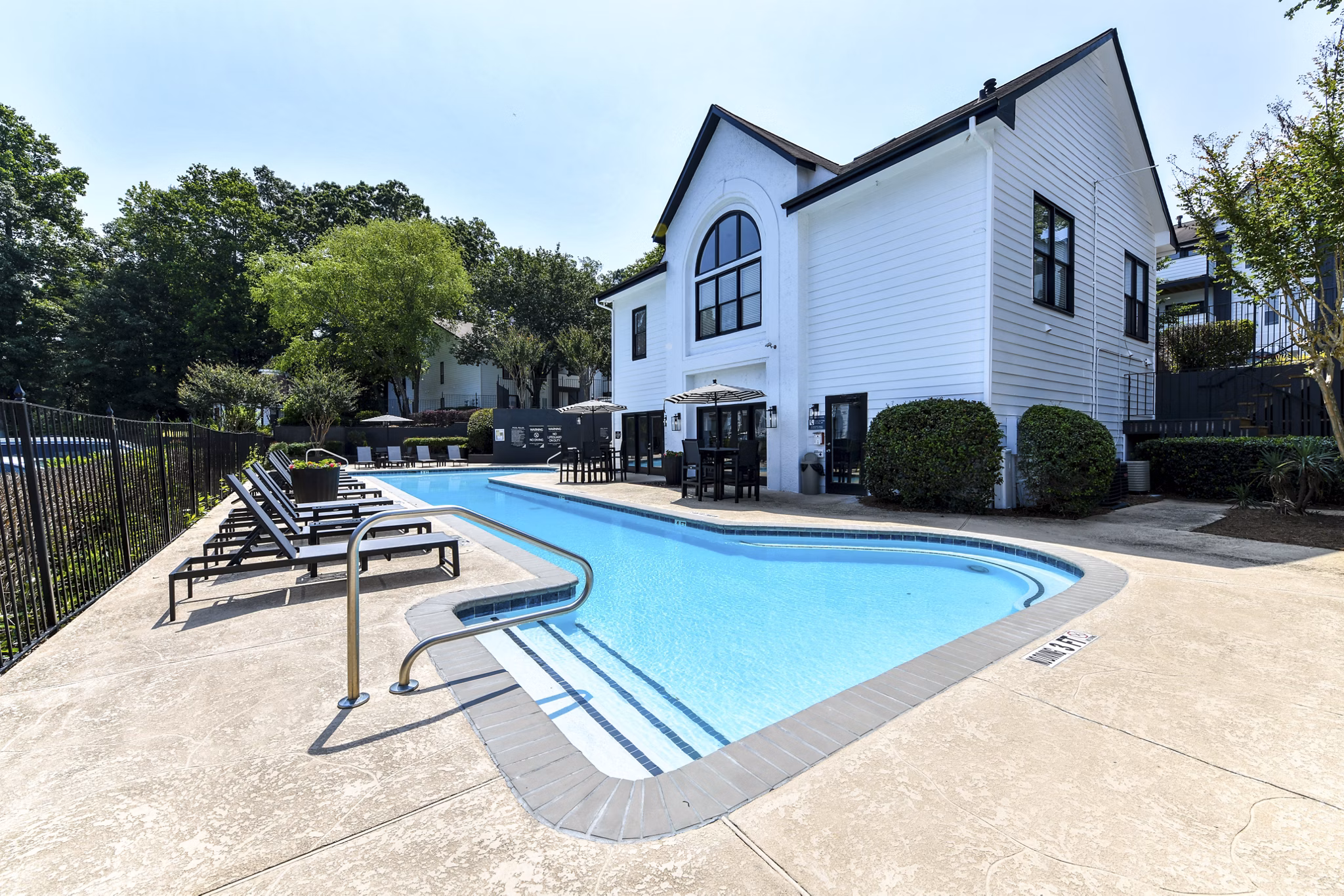 Poolside oasis featuring sparkling waters at Avana Dunwoody Apartments luxury community