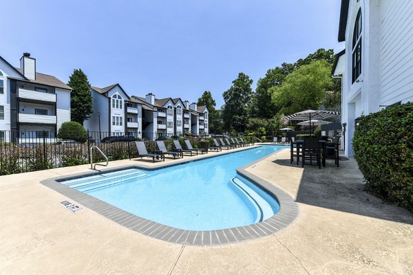 Inviting outdoor pool at Avana Dunwoody Apartments featuring stylish lounging areas and lush landscaping for relaxation and recreation