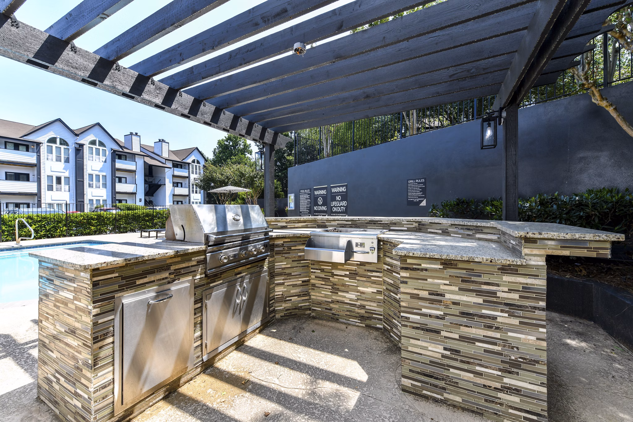 Grill area with outdoor seating at Avana Dunwoody Apartments, perfect for summer BBQs and gatherings