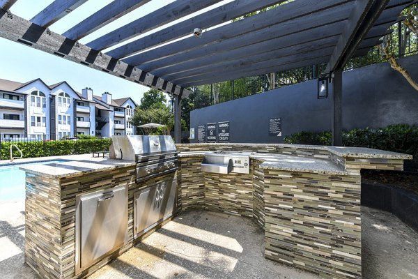 Grill area with outdoor seating at Avana Dunwoody Apartments, perfect for summer BBQs and gatherings
