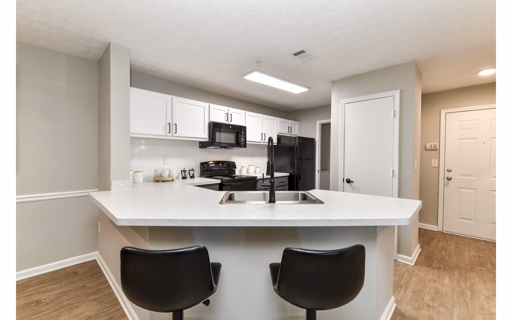Modern kitchen with sleek cabinetry and stainless steel appliances at Avana Twenty9 Apartments