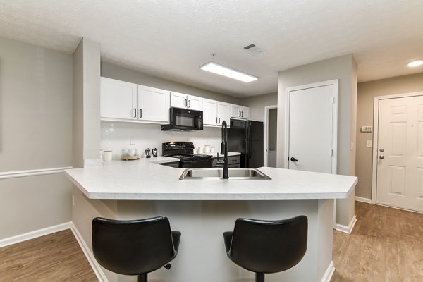 Modern kitchen with sleek cabinetry and stainless steel appliances at Avana Twenty9 Apartments