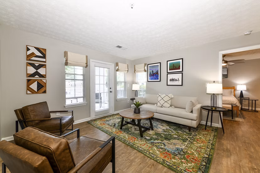 Spacious living room with modern decor in Avana Twenty9 Apartments, showcasing comfort and style in a luxury setting