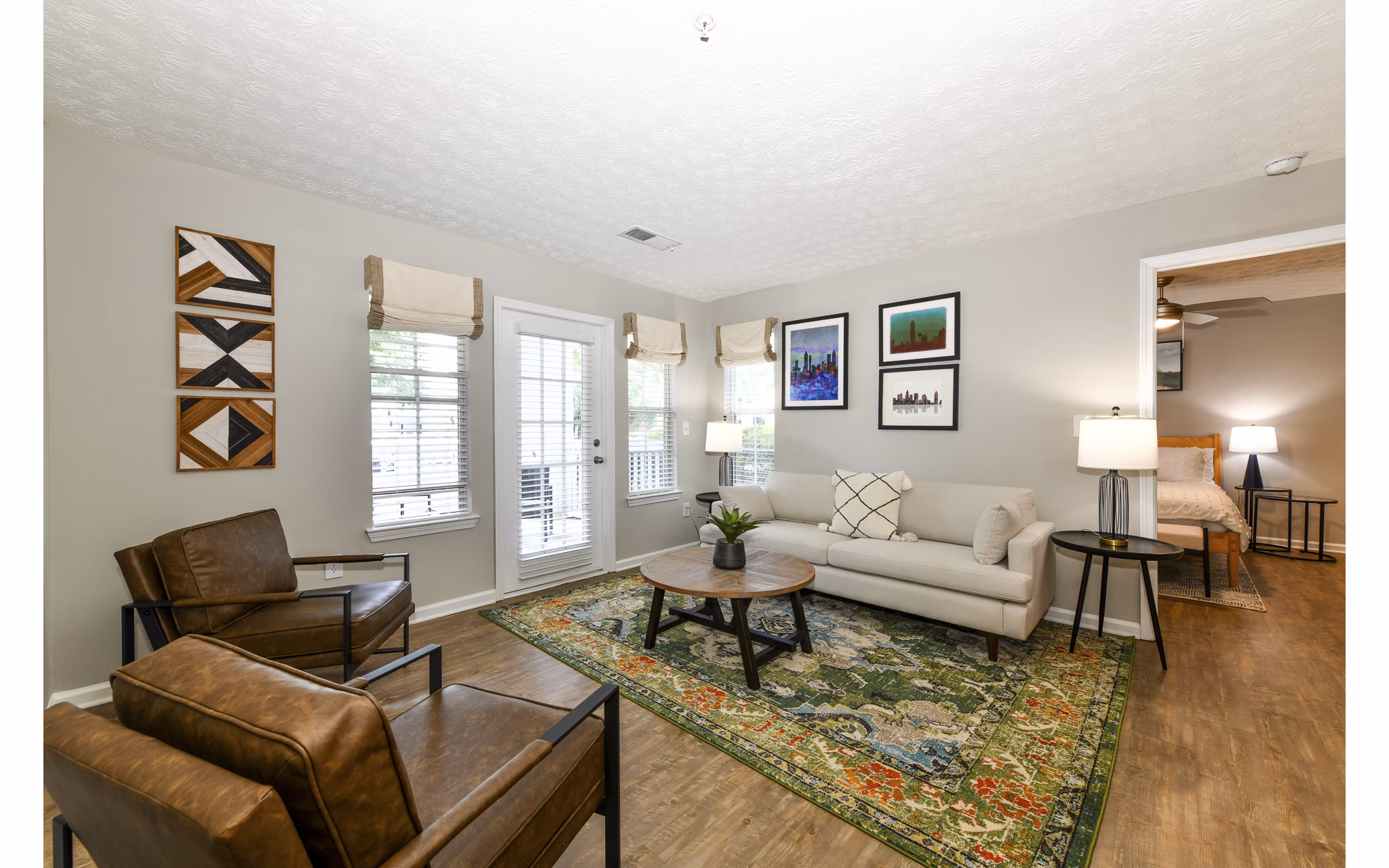 Spacious living room with modern decor in Avana Twenty9 Apartments, showcasing comfort and style in a luxury setting
