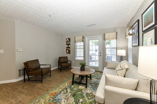 Modern living room with sleek furnishings and large windows in Avana Twenty9 Apartments